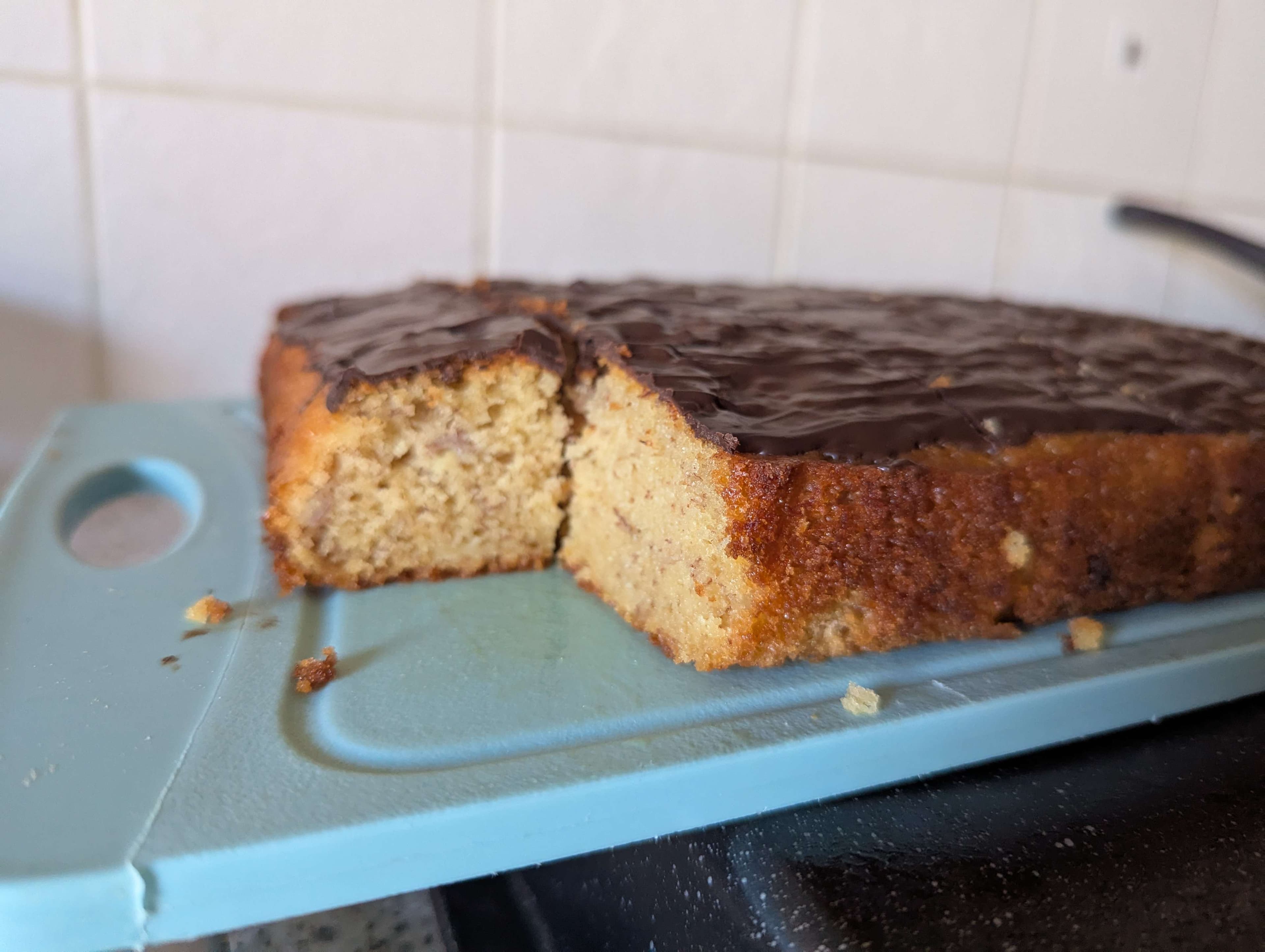 cross-section photograph of a banana bread traybake on a chopping board